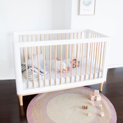 riya cot in white with baby inside